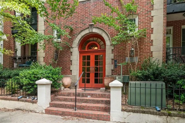 a front view of a house with plants