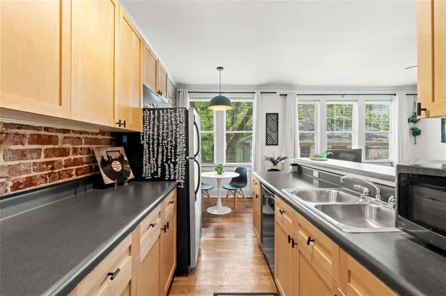 a kitchen with a large window and a sink