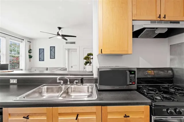 a kitchen with a sink and a stove