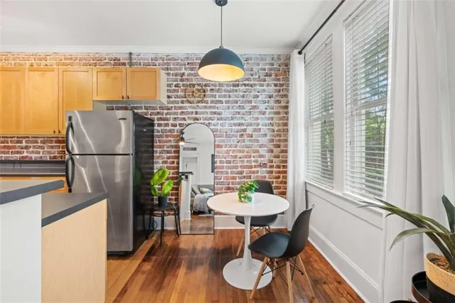 a dining room with furniture and a window