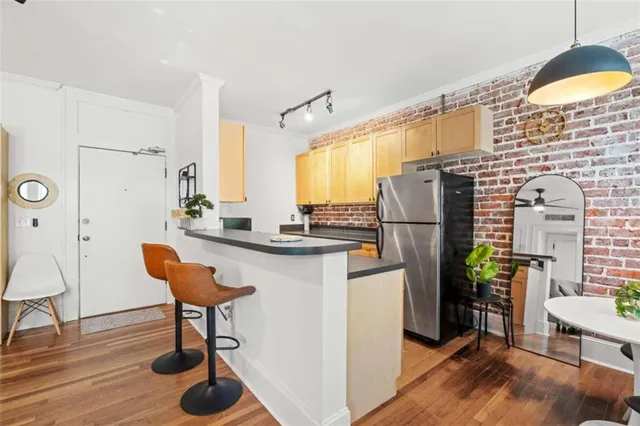 a kitchen with stainless steel appliances kitchen island granite countertop furniture a refrigerator and a dining table