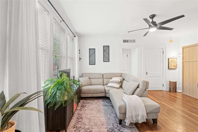a living room with furniture and a potted plant