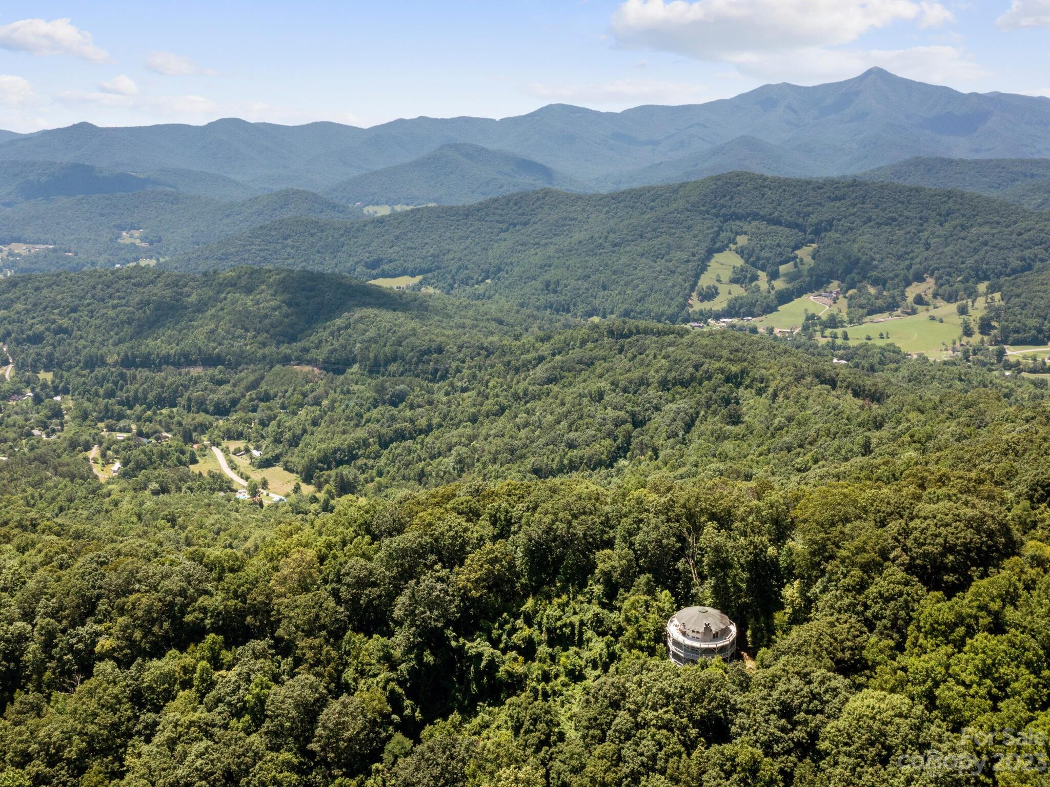 39 Rising Sun Road Candler, NC 28715 - Photo 16 of 41 a view of a lush green hillside and a houses