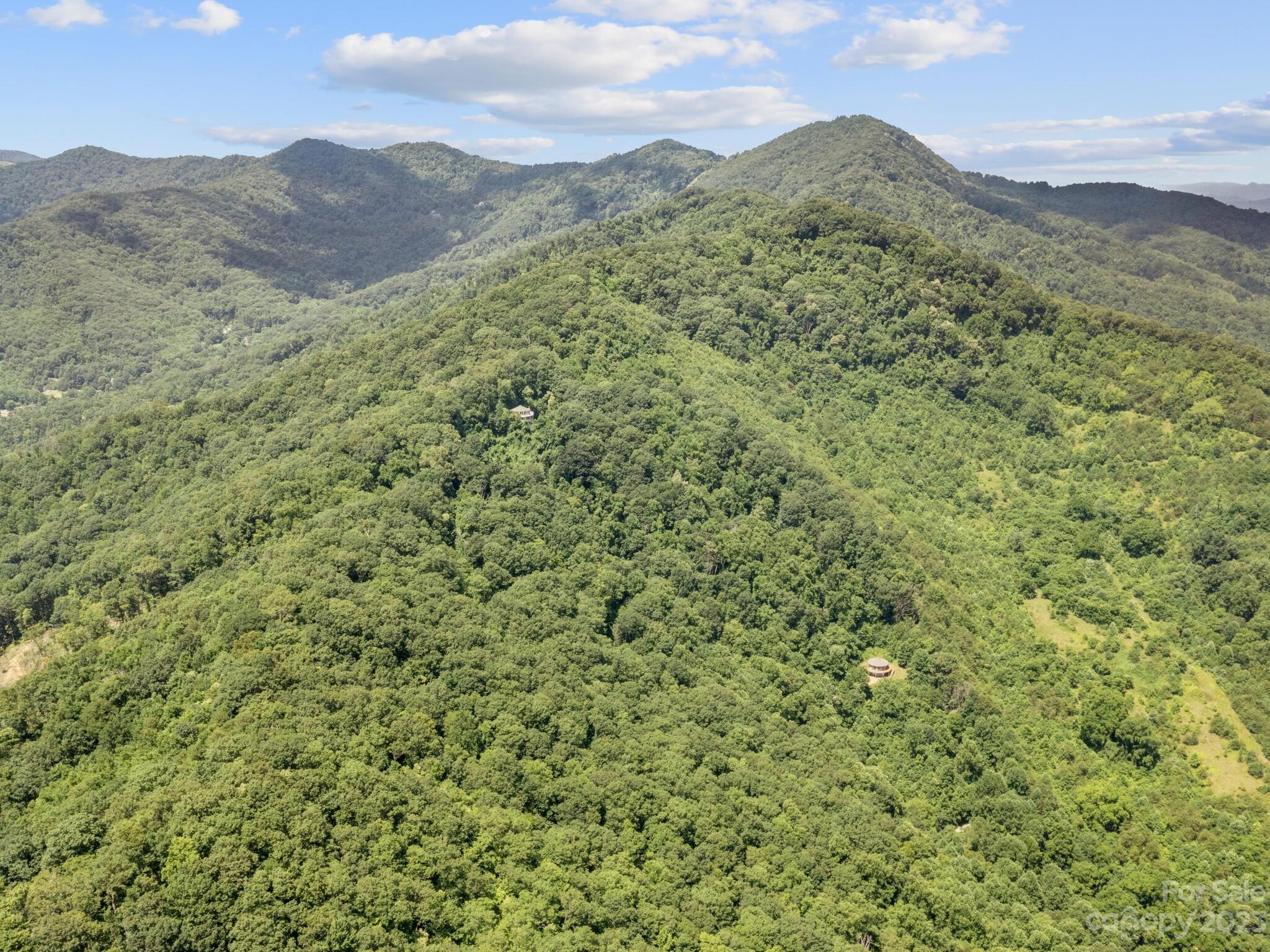 39 Rising Sun Road Candler, NC 28715 - Photo 18 of 41 a view of a lush green hillside and a mountain