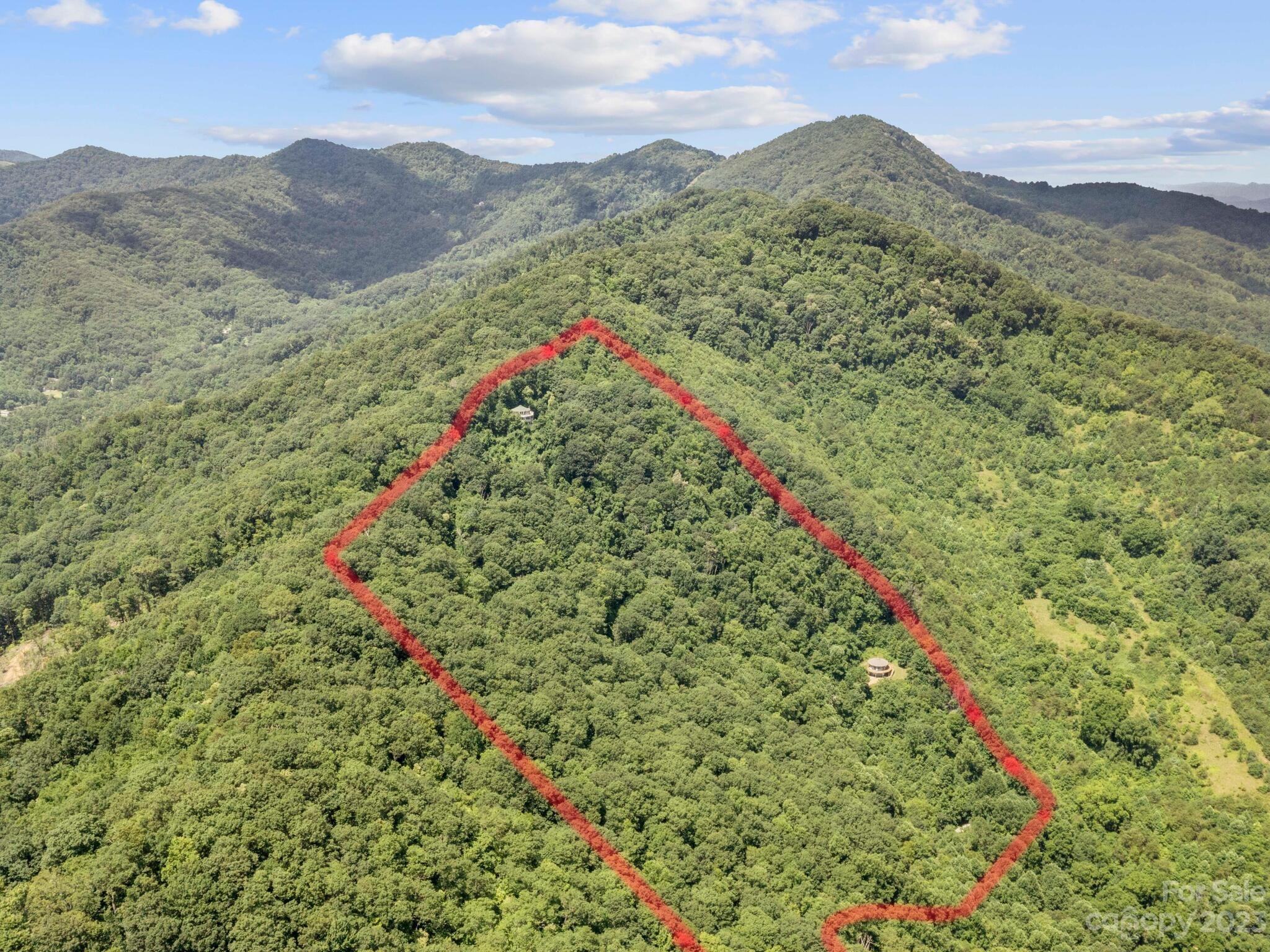 39 Rising Sun Road Candler, NC 28715 - Photo 19 of 41 a view of a lush green hillside and a building