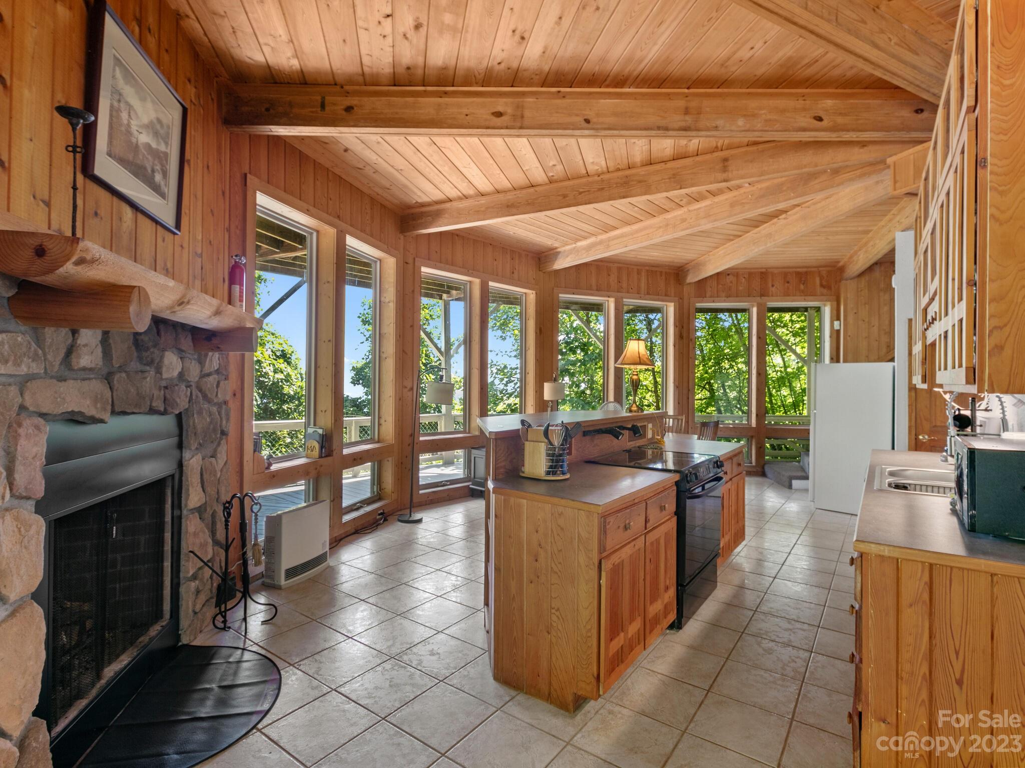 39 Rising Sun Road Candler, NC 28715 - Photo 20 of 41 a view of a kitchen with kitchen island granite countertop a large window and a counter space