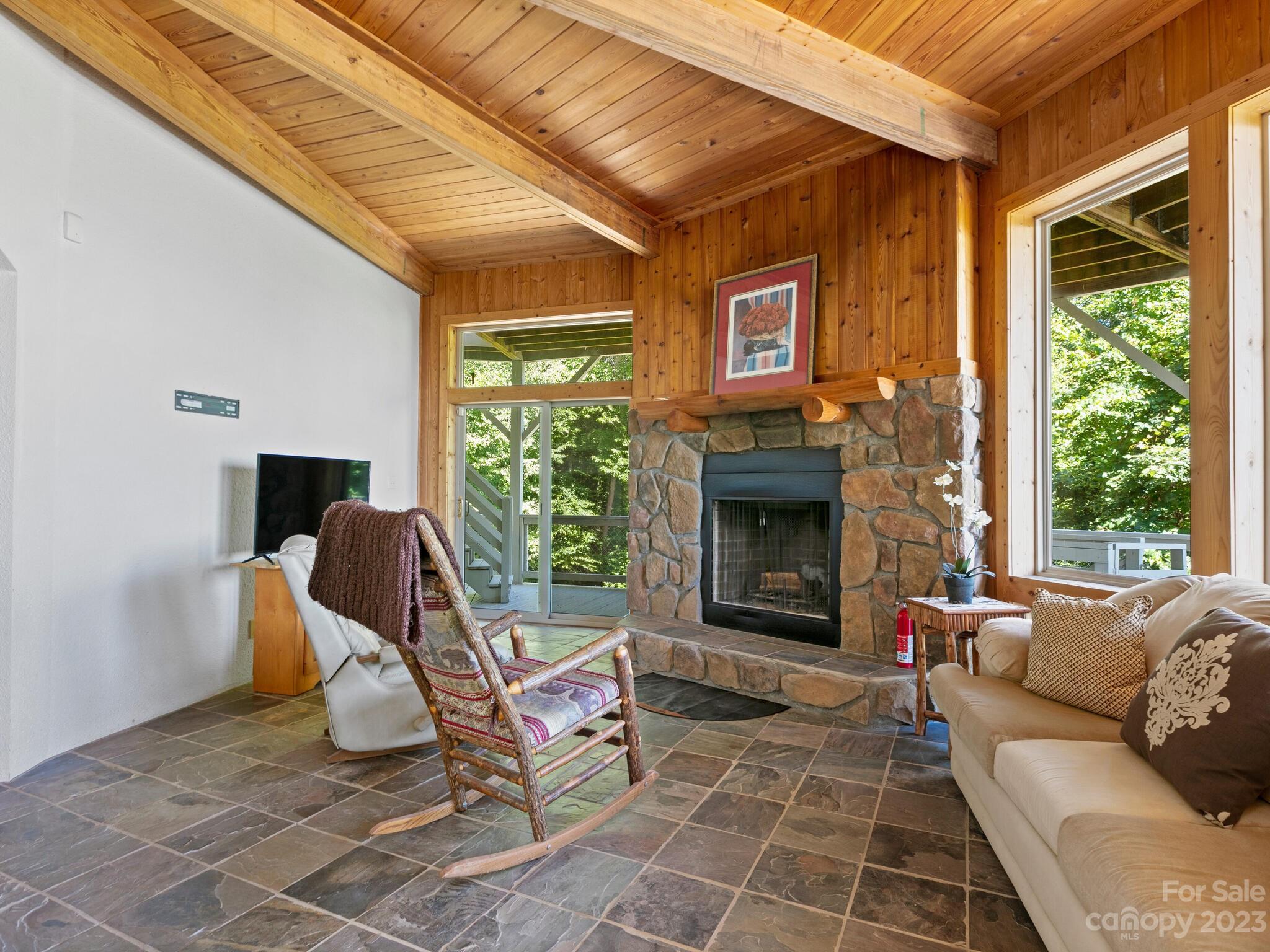 39 Rising Sun Road Candler, NC 28715 - Photo 28 of 41 a living room with furniture a window and a fireplace