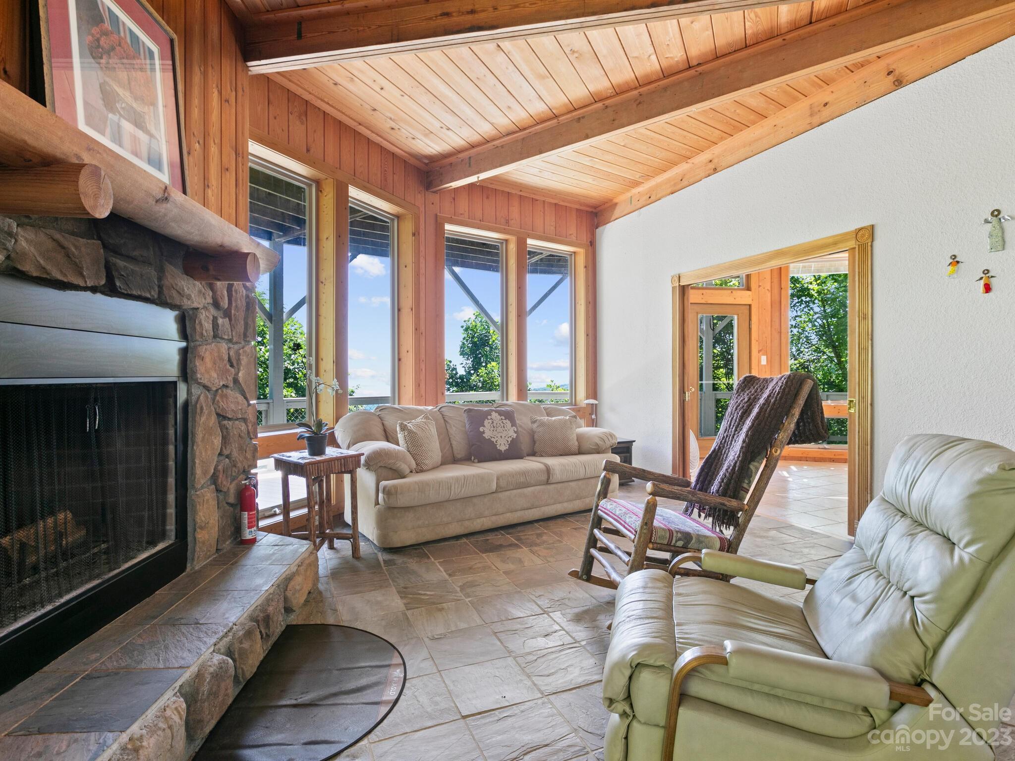 39 Rising Sun Road Candler, NC 28715 - Photo 29 of 41 a living room with furniture a large window and a fireplace