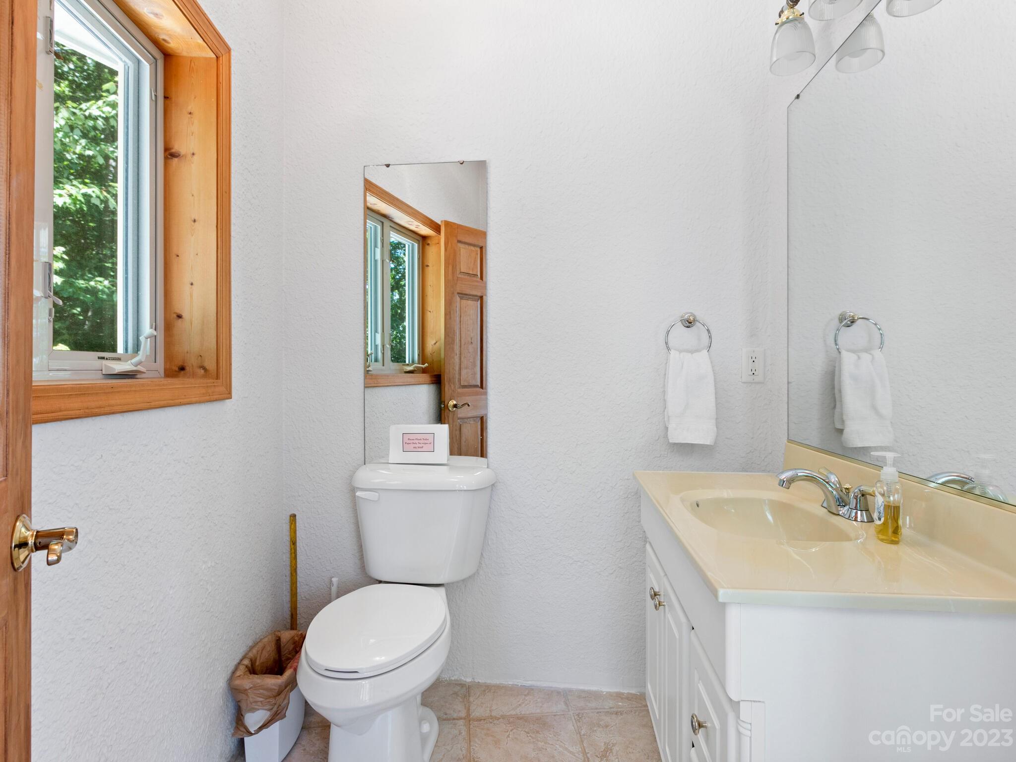 39 Rising Sun Road Candler, NC 28715 - Photo 36 of 41 a bathroom with a toilet sink and mirror