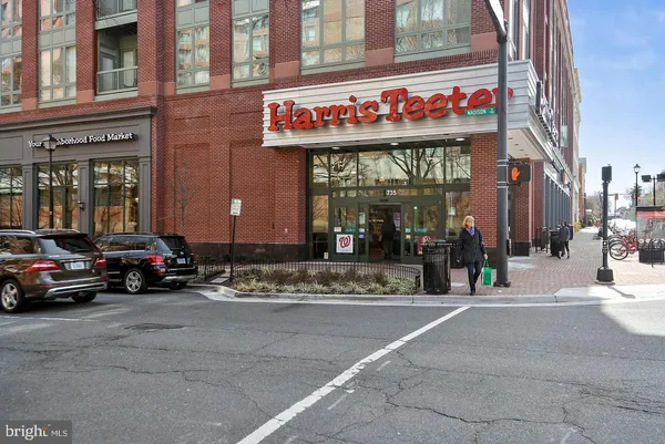a view of a street with a building and a people on a street