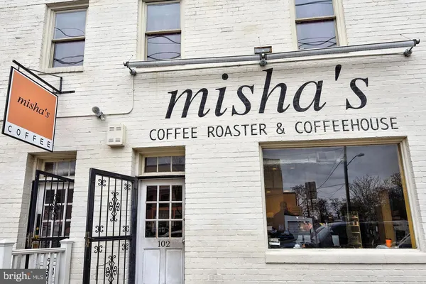 a view of a cafe with sitting area