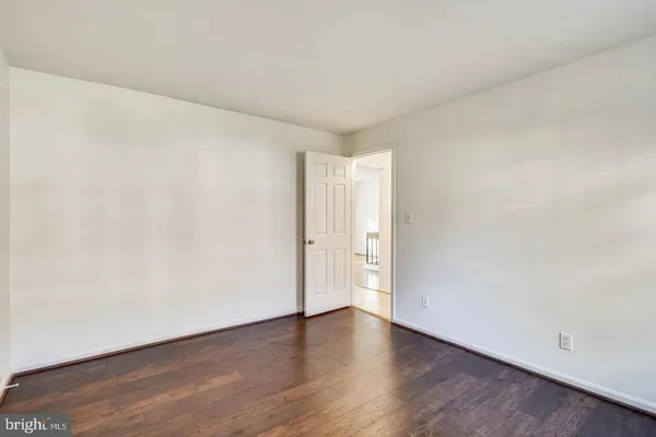 a view of an empty room and wooden floor