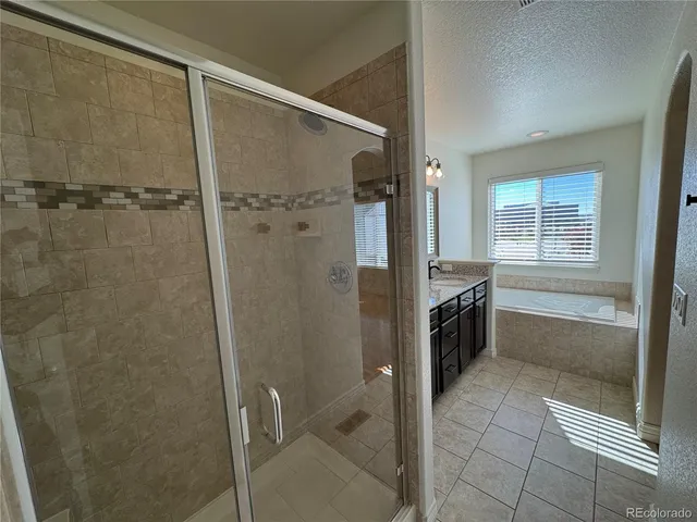 a bathroom with a shower and a sink