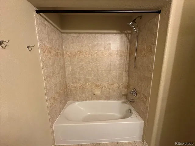 a bathroom with a shower and a bath tub