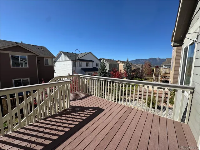 a view of a roof deck with wooden floor and fence