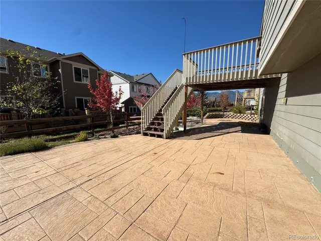 a view of a house with a wooden deck