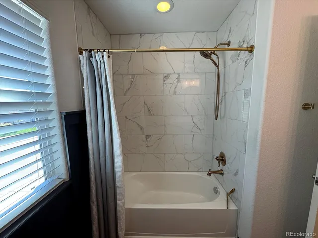a bathroom with a shower and a bathtub