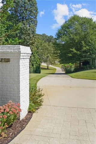 a front view of a house with plants