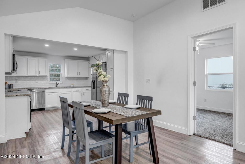 4623 Ribault Park Street Jacksonville, FL 32233 - Photo 11 of 30 a view of a dining room with furniture and wooden floor