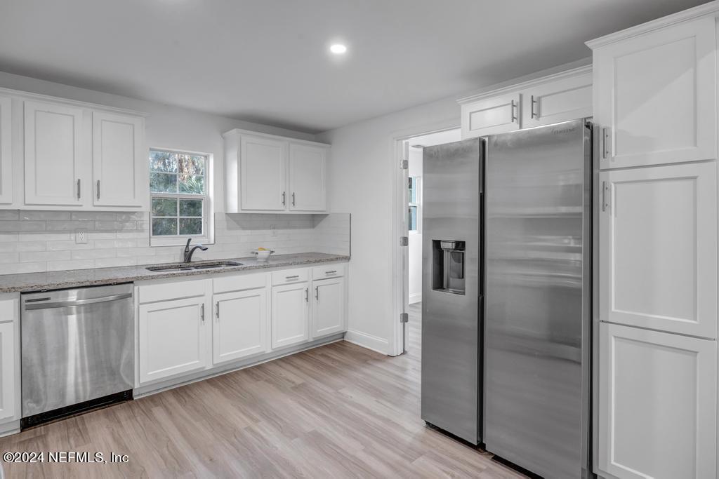 4623 Ribault Park Street Jacksonville, FL 32233 - Photo 13 of 30 a kitchen with stainless steel appliances granite countertop a refrigerator sink and cabinets