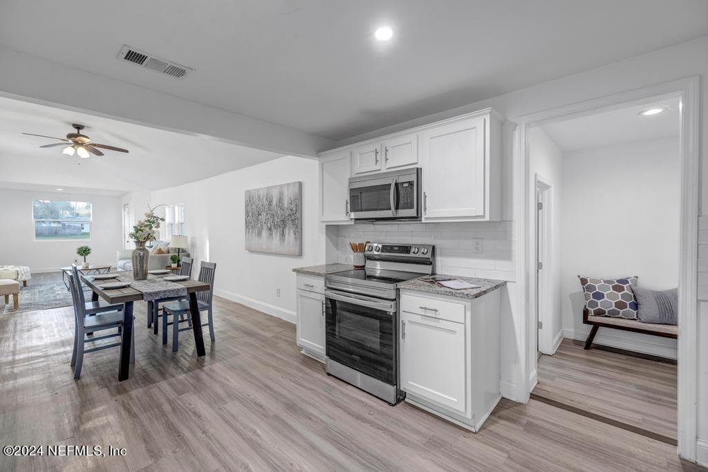 4623 Ribault Park Street Jacksonville, FL 32233 - Photo 15 of 30 a kitchen with a stove a sink and a refrigerator