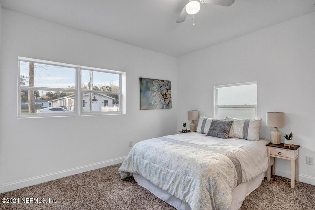 4623 Ribault Park Street Jacksonville, FL 32233 - Photo 17 of 30 a bedroom with a bed and a window