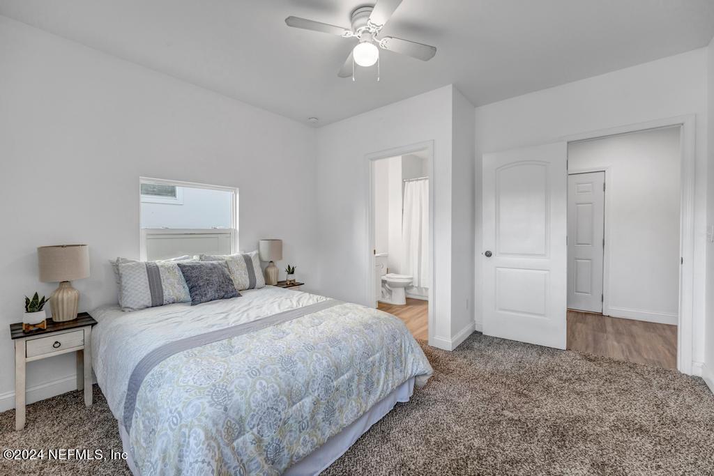 4623 Ribault Park Street Jacksonville, FL 32233 - Photo 18 of 30 a bedroom with a bed and a chandelier