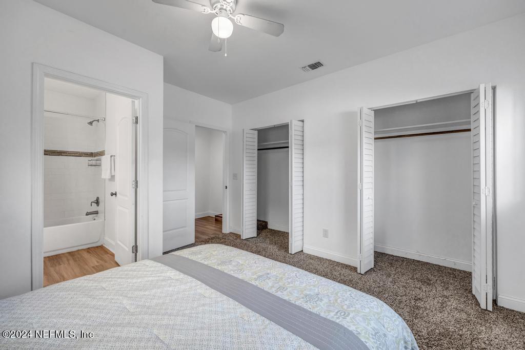 4623 Ribault Park Street Jacksonville, FL 32233 - Photo 19 of 30 a bedroom with a bed and a chandelier