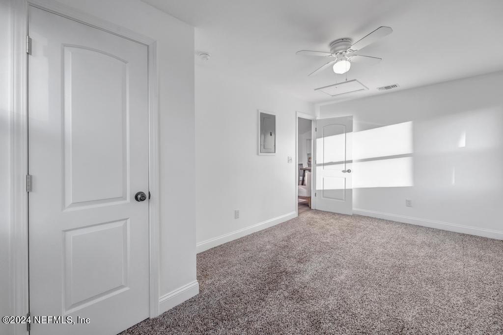 4623 Ribault Park Street Jacksonville, FL 32233 - Photo 22 of 30 an empty room with windows and fan