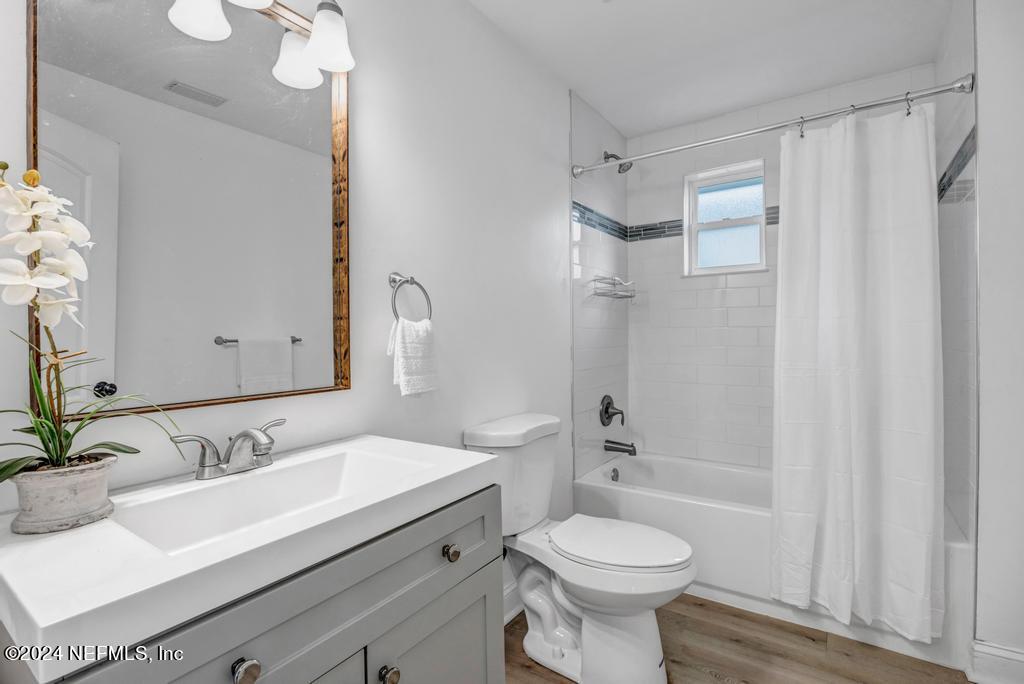 4623 Ribault Park Street Jacksonville, FL 32233 - Photo 23 of 30 a bathroom with a sink toilet a mirror and shower