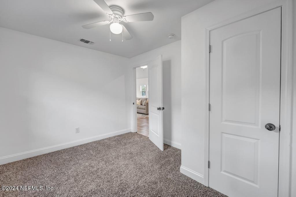 4623 Ribault Park Street Jacksonville, FL 32233 - Photo 25 of 30 an empty room with fan and entrance