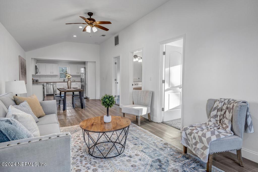 4623 Ribault Park Street Jacksonville, FL 32233 - Photo 4 of 30 a living room with furniture and a chandelier