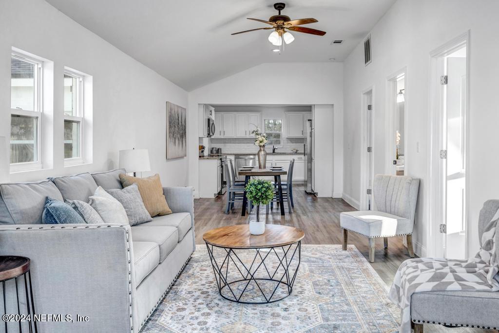 4623 Ribault Park Street Jacksonville, FL 32233 - Photo 5 of 30 a living room with furniture and a chandelier