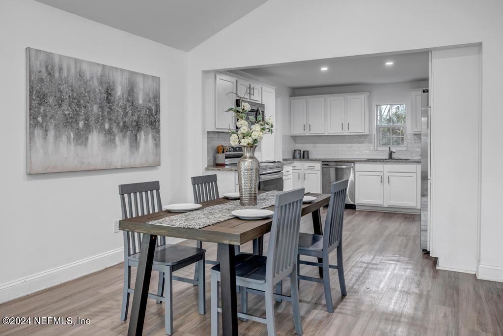 4623 Ribault Park Street Jacksonville, FL 32233 - Photo 10 of 30 a view of a dining room with furniture and wooden floor