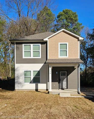 a house with trees in the background