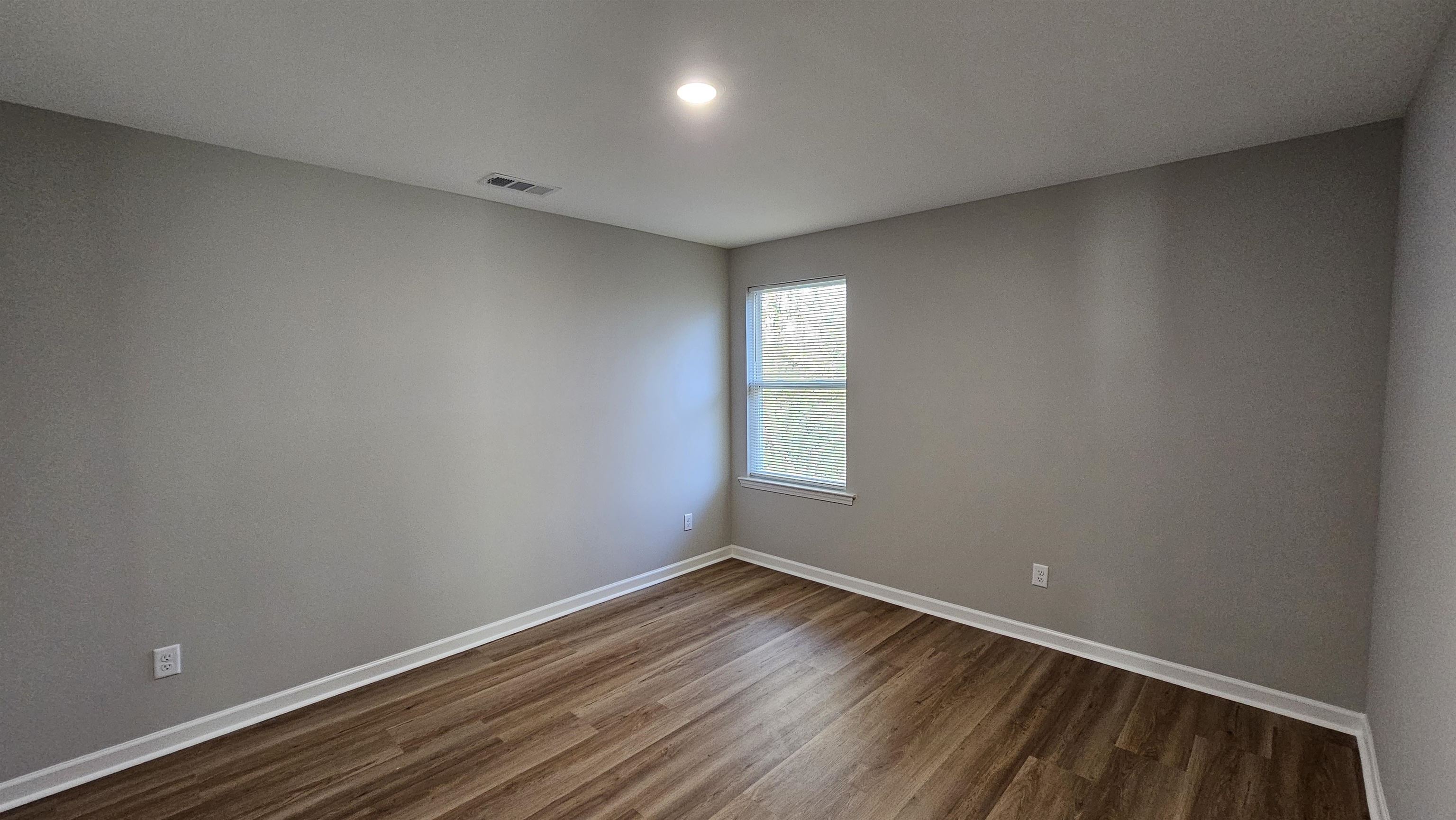 2234 East Alcy Road Memphis, TN 38114 - Photo 21 of 23 a view of room with window and wooden floor
