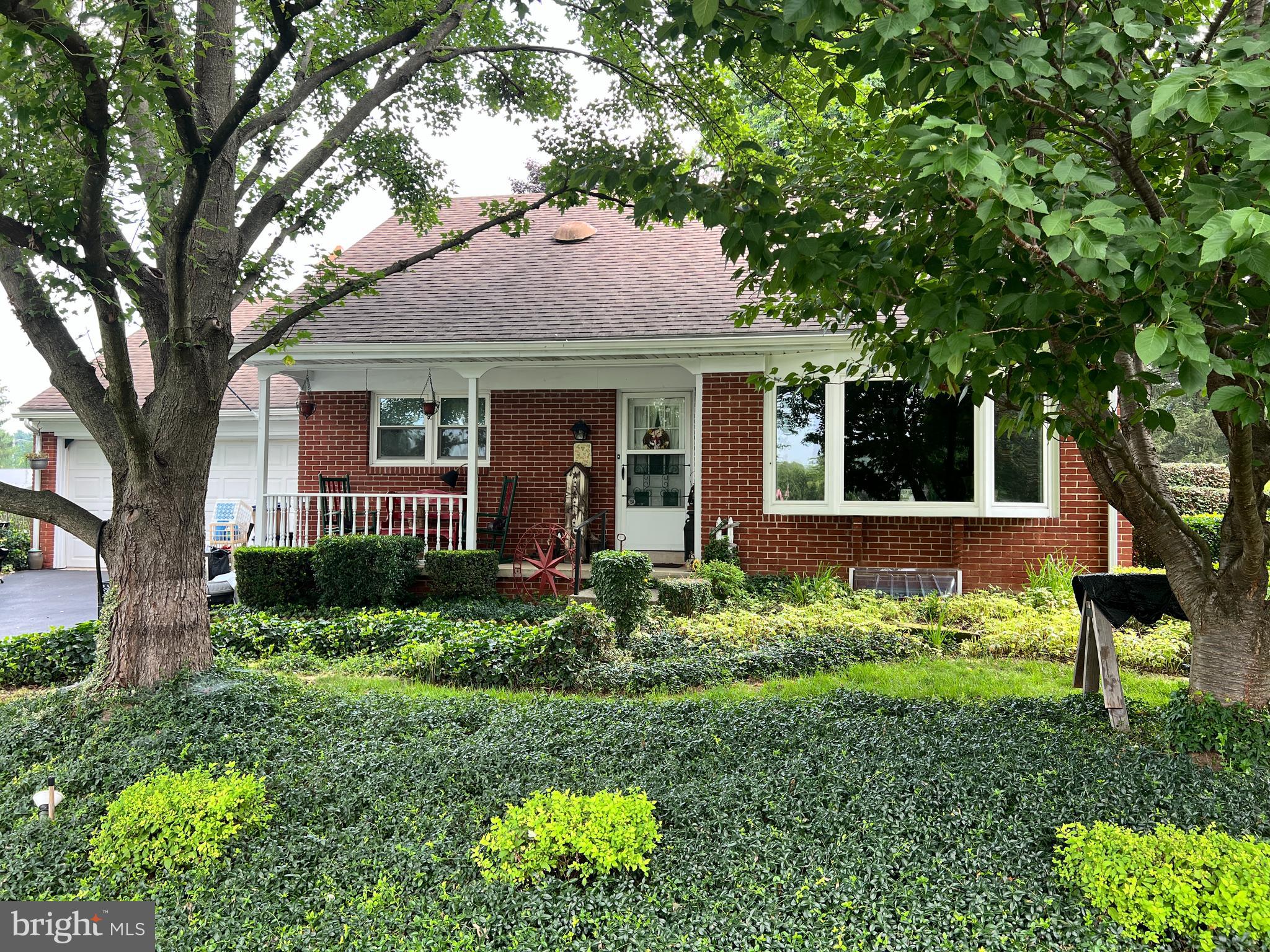 51 South Snyder Street Manheim, PA 17545 - Photo 1 of 32 a front view of a house with a yard and potted plants