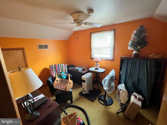 a living room with furniture a rug and a chandelier