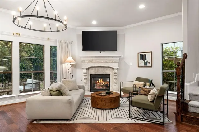 a living room with fireplace furniture and a flat screen tv