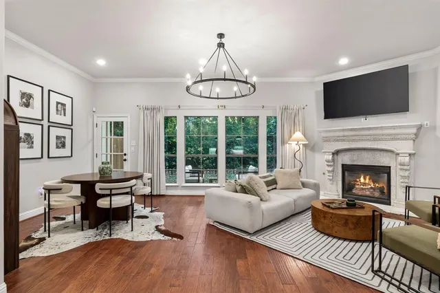 a living room with furniture kitchen view and a chandelier