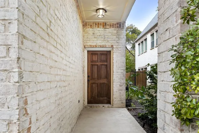a view of a hallway with wooden floor and closet