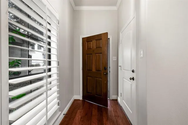 a view of a bedroom with a door and wooden floor