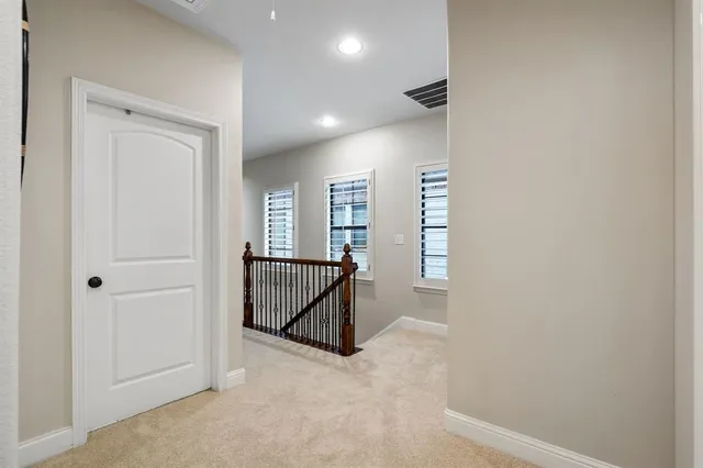 a view of hallway with windows