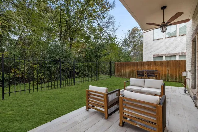 a view of a chair and table in backyard of the house