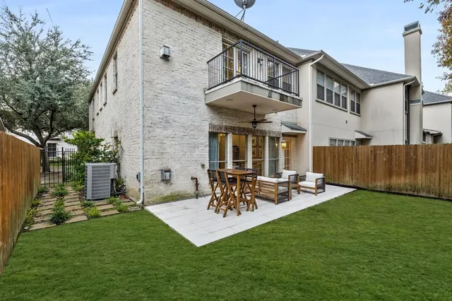 a view of a patio with table and chairs