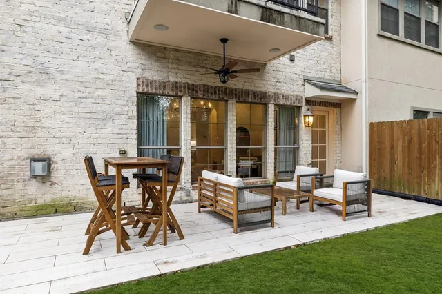 a view of a patio with table and chairs and potted plants