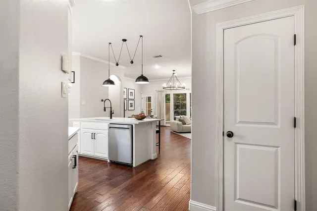 a kitchen with stainless steel appliances granite countertop a stove and a wooden floors