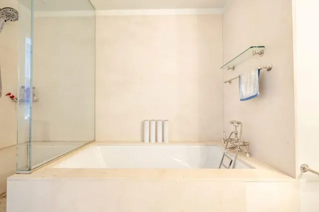 a bathroom with a bathtub and shower