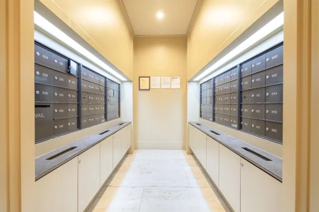 a large white kitchen with granite countertop a sink and a large window