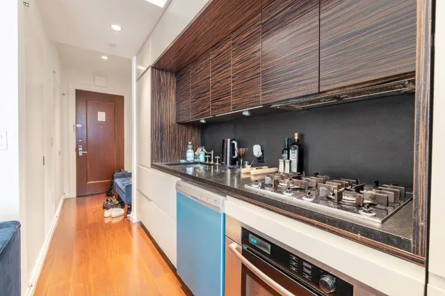 a kitchen with stainless steel appliances kitchen island granite countertop a sink and cabinets